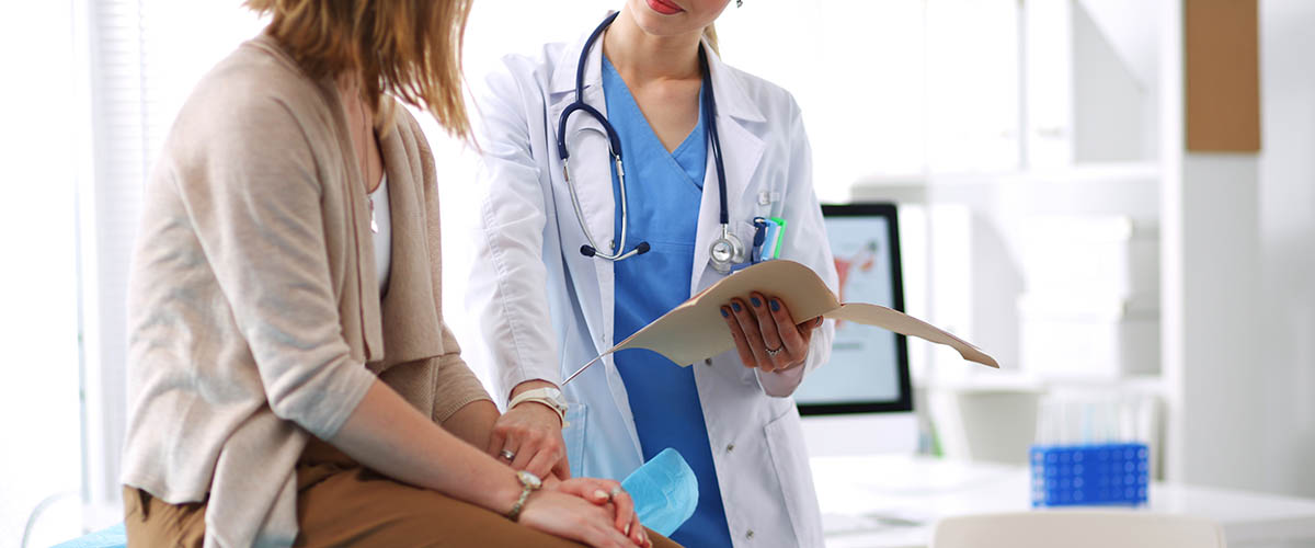 Doctor,And,Patient,Discussing,Something,While,Sitting,At,The,Table